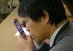 User viewing mobile screen with a magnifying glass